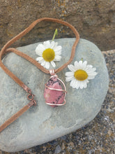Load image into Gallery viewer, Rhodonite pendant necklace on a brown leather cord with a clasp.
